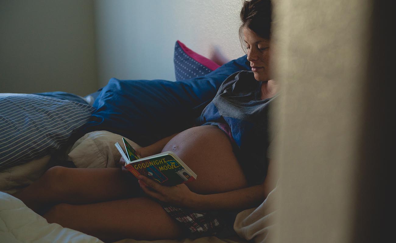 pregnant woman relaxing and reading a book